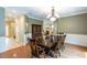 Formal dining room with a large table, hardwood floors, wainscoting, and an elegant chandelier that offers great style at 10 Foxhunter Flt, Ormond Beach, FL 32174