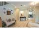 Inviting foyer with staircase, bench, and views of the living room with fireplace and a decorative tile floor design at 10 Foxhunter Flt, Ormond Beach, FL 32174