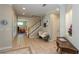 Bright foyer with decorative tile, staircase, and entry to a living room, with a view of the interior at 10 Foxhunter Flt, Ormond Beach, FL 32174