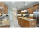 Traditional kitchen features wooden cabinets, stainless steel appliances, and a granite island perfect for cooking at 10 Foxhunter Flt, Ormond Beach, FL 32174