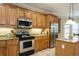 Well-equipped kitchen featuring stainless steel appliances, granite countertops, and custom wood cabinetry at 10 Foxhunter Flt, Ormond Beach, FL 32174
