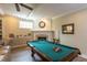 The living room boasts a fireplace, pool table, and coffered ceilings, creating an elegant and functional space at 10 Foxhunter Flt, Ormond Beach, FL 32174