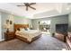 Main bedroom with tray ceilings, access to a private balcony, and a large dresser at 10 Foxhunter Flt, Ormond Beach, FL 32174