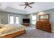 Main bedroom with tray ceilings, access to a private balcony, and large dresser at 10 Foxhunter Flt, Ormond Beach, FL 32174