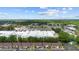 Aerial view of the property featuring condo community, mature trees, and nearby businesses at 101 Grand Plaza Dr # G30, Orange City, FL 32763