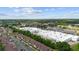 An aerial view of a community with houses, commercial buildings, trees, roads, and plenty of parking spaces at 101 Grand Plaza Dr # G30, Orange City, FL 32763
