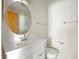Bathroom featuring a white vanity, an oval mirror, and a white toilet at 101 Grand Plaza Dr # G30, Orange City, FL 32763