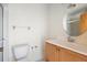 This bathroom features a vanity with a wood cabinet, a large mirror, and a white toilet at 101 Grand Plaza Dr # G30, Orange City, FL 32763