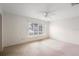 Airy bedroom with neutral tones, ceiling fan, and large window offering plenty of natural light at 101 Grand Plaza Dr # G30, Orange City, FL 32763