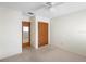 Neutral bedroom featuring closet with louvered doors, carpeted floors, and an exit door at 101 Grand Plaza Dr # G30, Orange City, FL 32763