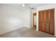 This neutral bedroom has carpeted floors, a fan, closet with louvered doors, and an exit door at 101 Grand Plaza Dr # G30, Orange City, FL 32763