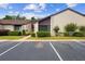 Townhouse exterior shows parking with manicured lawns and shrubbery adding to the curb appeal on a sunny day at 101 Grand Plaza Dr # G30, Orange City, FL 32763