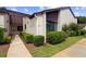 Charming townhouse featuring manicured landscaping, neutral stucco, and dark accents, creating an inviting curb appeal at 101 Grand Plaza Dr # G30, Orange City, FL 32763