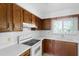 Well-lit kitchen boasts bright countertops, wood cabinets, and modern appliances, creating a cozy and functional space at 101 Grand Plaza Dr # G30, Orange City, FL 32763