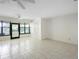 Bright living room with tile flooring, ceiling fan, sliding glass door, and a window for natural light and ventilation at 101 Grand Plaza Dr # G30, Orange City, FL 32763