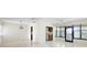 Open-concept living area with tile flooring, ceiling fans, view of the kitchen, and natural light, creating a cozy space at 101 Grand Plaza Dr # G30, Orange City, FL 32763