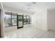 Bright sunroom featuring tile floors, ceiling fan, and sliding glass door for seamless indoor-outdoor living at 101 Grand Plaza Dr # G30, Orange City, FL 32763