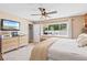 Bedroom features neutral decor, ceiling fan, dresser, and a view of the private backyard at 1020 Hornbeam St, Oviedo, FL 32765