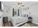 Relaxing bedroom with a ceiling fan, wood floors, and a view of the backyard at 1020 Hornbeam St, Oviedo, FL 32765
