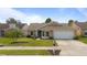 Charming single-story home featuring a well-manicured lawn, attached garage, and quaint landscaping at 1020 Hornbeam St, Oviedo, FL 32765