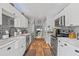 Bright kitchen with white cabinetry, farmhouse sink, stainless steel appliances and gray subway tile at 1020 Hornbeam St, Oviedo, FL 32765