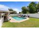 Gorgeous in-ground pool with grass surround, lounge chairs, and privacy fence at 1020 Hornbeam St, Oviedo, FL 32765
