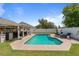 Inviting backyard featuring a sparkling pool, covered patio, and well-manicured lawn at 1020 Hornbeam St, Oviedo, FL 32765