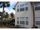 A well maintained condo with black stairs, multiple windows, and palm trees in a community at 1083 S Hiawassee Rd # 611, Orlando, FL 32835