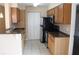 Kitchen featuring stainless steel appliances, granite countertops, and wood cabinetry at 1083 S Hiawassee Rd # 611, Orlando, FL 32835