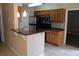 A kitchen featuring modern stainless steel appliances, beautiful granite counters, and ample cabinet space at 1083 S Hiawassee Rd # 611, Orlando, FL 32835