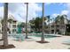 Community pool with lounge chairs, patio furniture, and towering palm trees at 1083 S Hiawassee Rd # 611, Orlando, FL 32835