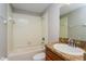 Bathroom featuring a shower over tub with white tile surround, granite countertop, and neutral paint color at 109 Bel Fiore Cv, Sanford, FL 32773