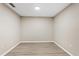 Empty bedroom featuring laminated floor, white walls and baseboards, and recessed lighting at 109 Bel Fiore Cv, Sanford, FL 32773