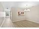 Bright dining area with modern chandelier and stylish vinyl flooring, perfect for gatherings at 109 Bel Fiore Cv, Sanford, FL 32773