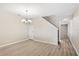 Spacious dining area with stairs, vinyl floors and elegant chandelier for a modern touch at 109 Bel Fiore Cv, Sanford, FL 32773
