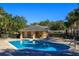 Community pool with brick pavers and a pool house overlooking the serene, clear, blue water at 109 Bel Fiore Cv, Sanford, FL 32773
