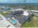 Aerial view featuring a condo complex with a sparkling pool and beachfront access at 1233 N Atlantic Ave # 3090, Daytona Beach, FL 32118