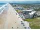 Wide aerial view of condo complex, beach, and surrounding neighborhood at 1233 N Atlantic Ave # 3090, Daytona Beach, FL 32118