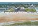 Aerial view highlighting a beachfront condo near the ocean with beachgoers at 1233 N Atlantic Ave # 3090, Daytona Beach, FL 32118