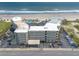 Aerial shot of a beachfront building with a pool, parking, and direct access to a pristine sandy beach at 1233 N Atlantic Ave # 3090, Daytona Beach, FL 32118