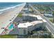 Aerial view of the condo complex with ocean view, pool, and ample parking at 1233 N Atlantic Ave # 3090, Daytona Beach, FL 32118