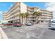 Exterior view of a resort featuring multiple stories, palm trees, and convenient parking at 1233 N Atlantic Ave # 3090, Daytona Beach, FL 32118