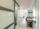 Open living space featuring sliding barn doors, a flat-screen TV, and comfortable seating with a calming view at 1233 N Atlantic Ave # 3090, Daytona Beach, FL 32118