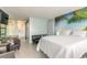 Inviting living space with a queen bed, sleeper sofa, and palm mural for a relaxing coastal feel at 1233 N Atlantic Ave # 3090, Daytona Beach, FL 32118