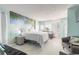 Bright, updated bedroom with a queen bed, palm tree wall art, and views of the ocean at 1233 N Atlantic Ave # 3090, Daytona Beach, FL 32118