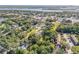 Scenic aerial view of a charming, tree-lined neighborhood, with views of Saint Joseph Sound at 128 Oakridge Ave, Edgewater, FL 32132
