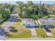 Aerial view of a charming home with a green lawn, next to a quiet residential street at 128 Oakridge Ave, Edgewater, FL 32132