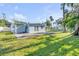 Backyard with lush lawn and patio area; perimeter fencing adds to the property's appeal at 128 Oakridge Ave, Edgewater, FL 32132