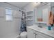 Bathroom features subway tile shower and single sink vanity at 128 Oakridge Ave, Edgewater, FL 32132