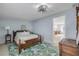 Charming bedroom showcasing a tropical themed rug, ceiling fan and neutral colored walls at 128 Oakridge Ave, Edgewater, FL 32132
